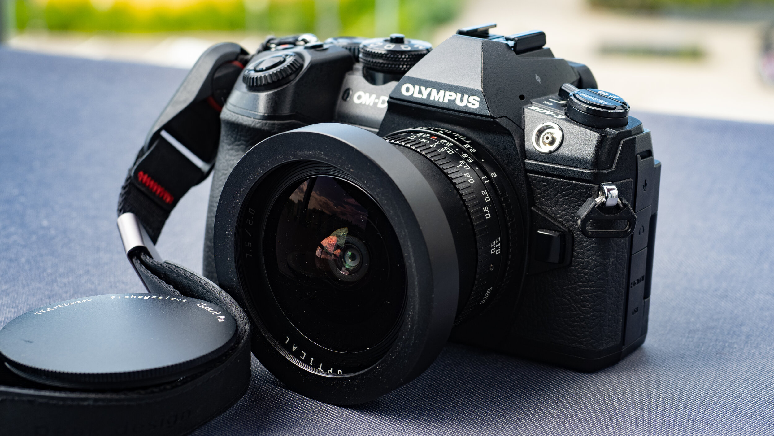 Remove the middle part of the lens cap when using it on a FF camera. It will produce a circular image.